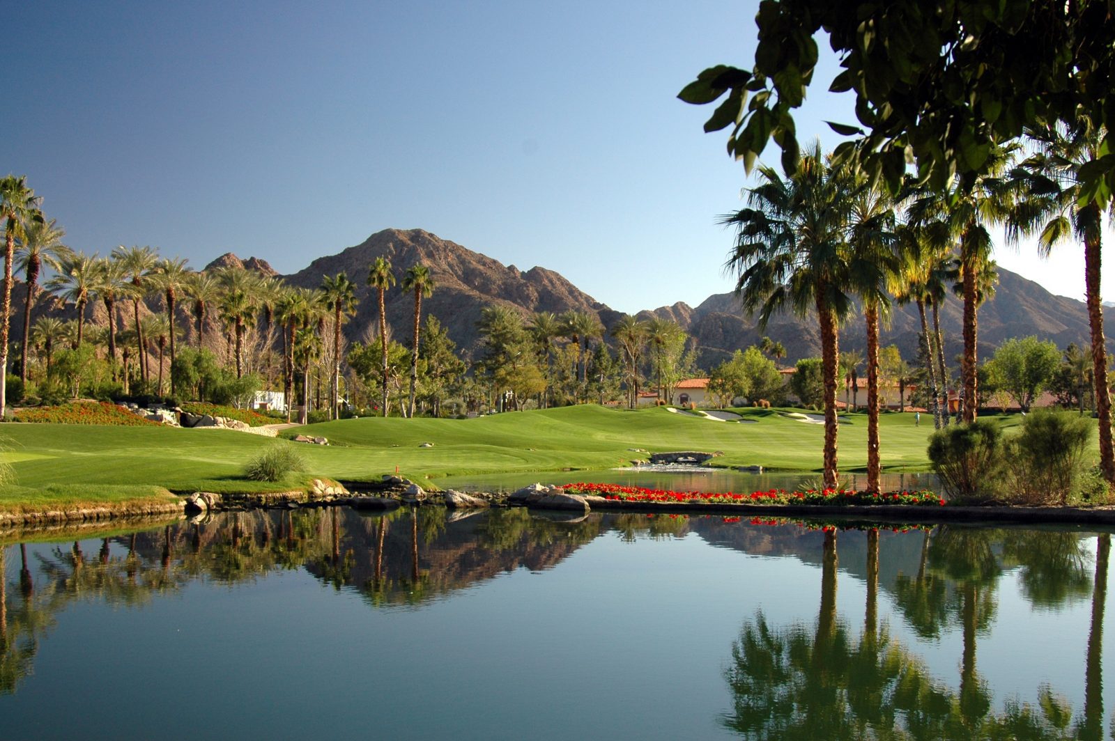 A golf course with mountains in the background.