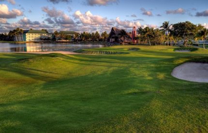 A view of a golf course with water in the background.