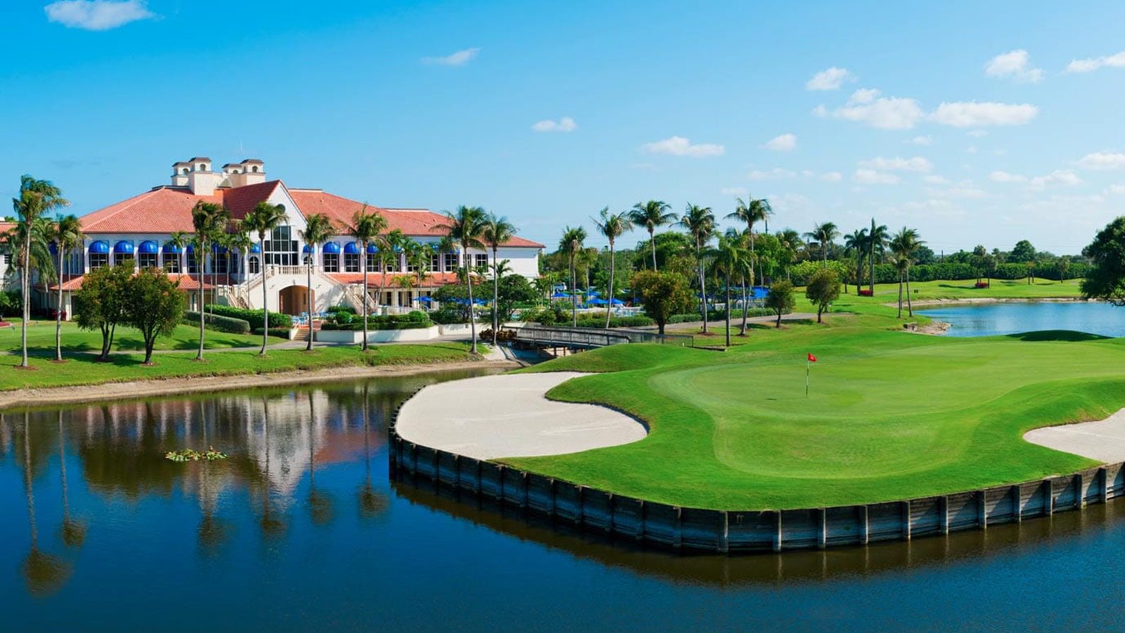 A golf course with a large building in the background.