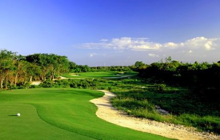 A golf course with green grass and trees.
