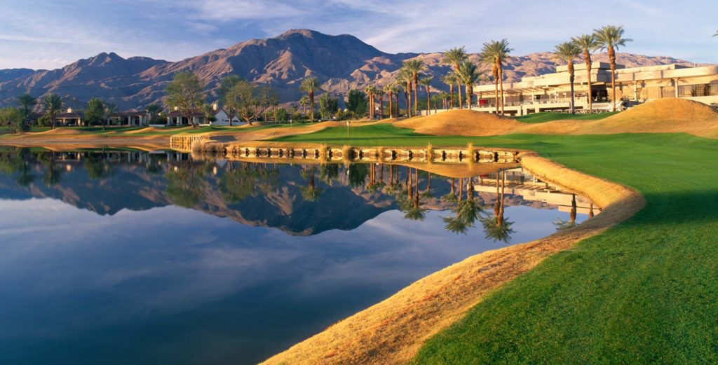 A golf course with mountains in the background.