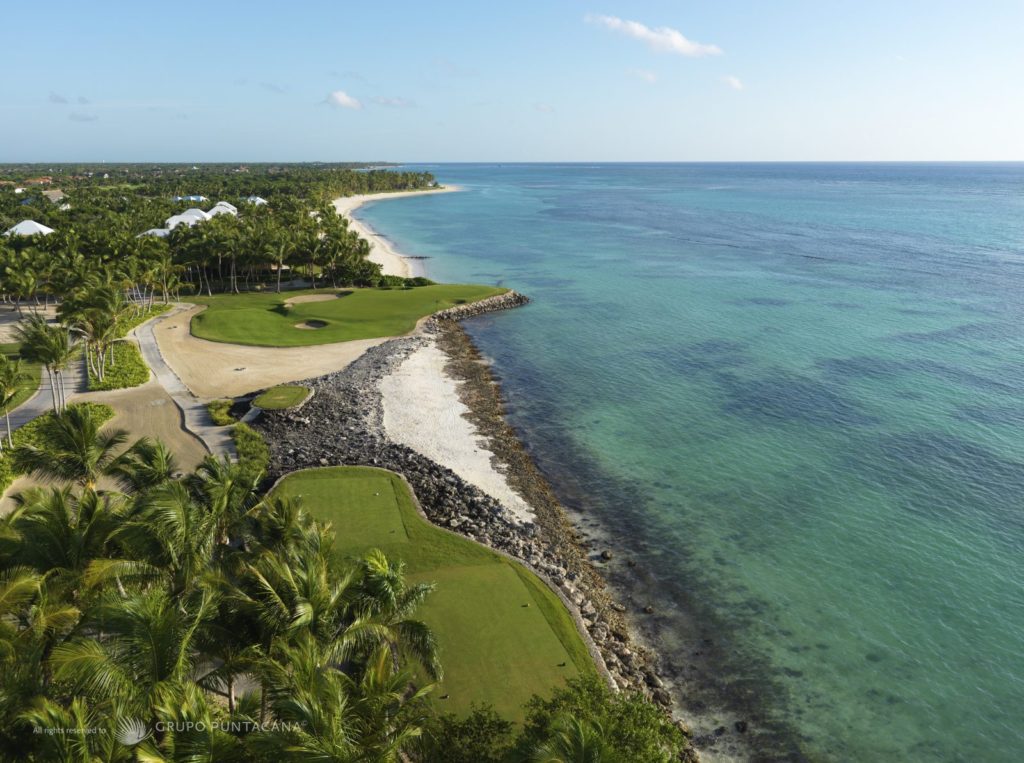 A view of the ocean from above, showing a golf course.