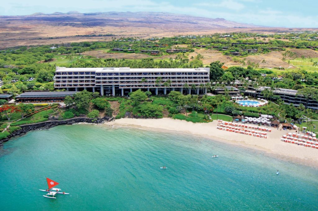 A resort with an ocean view and a beach.