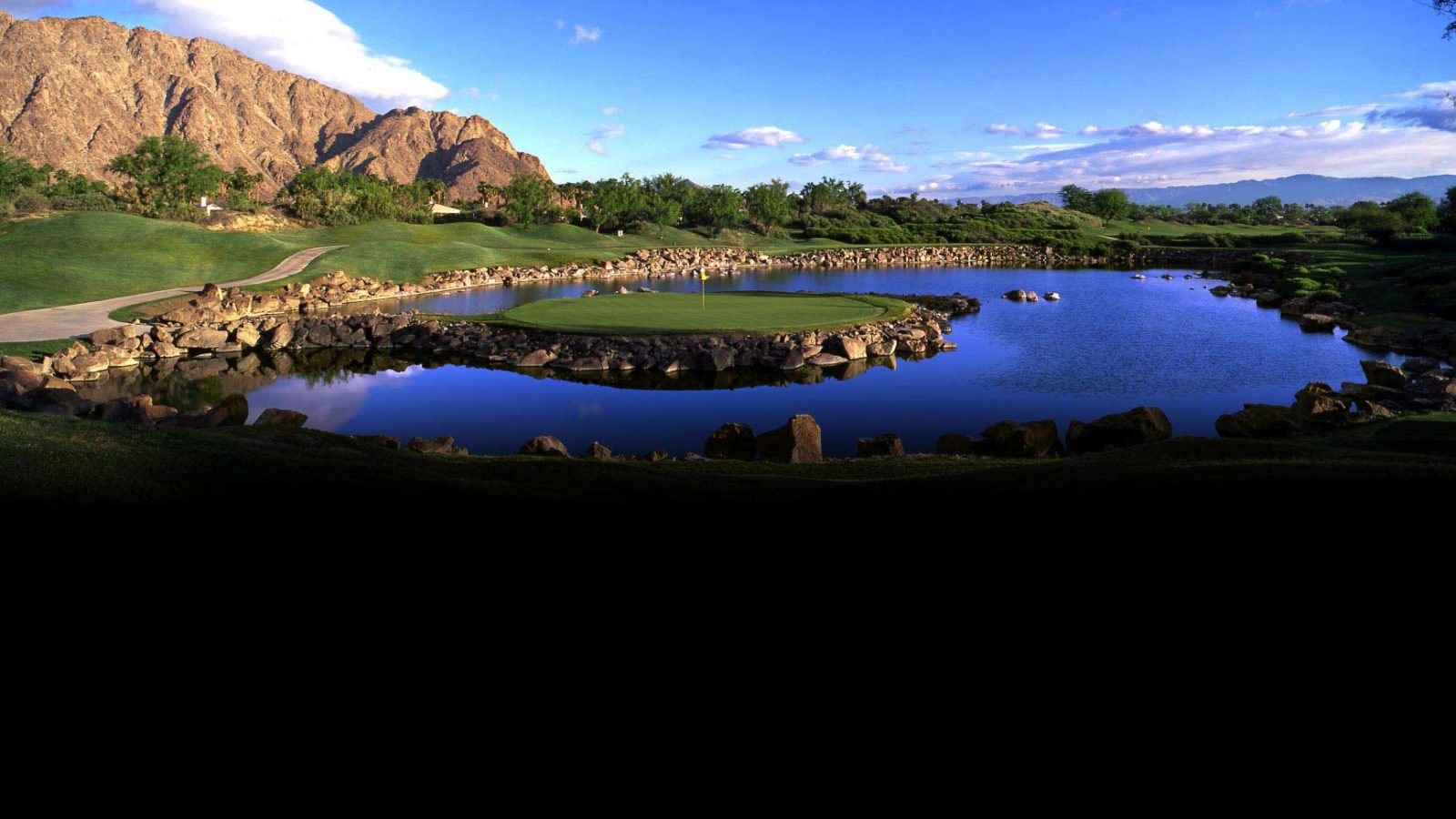 A view of the golf course from across the water.