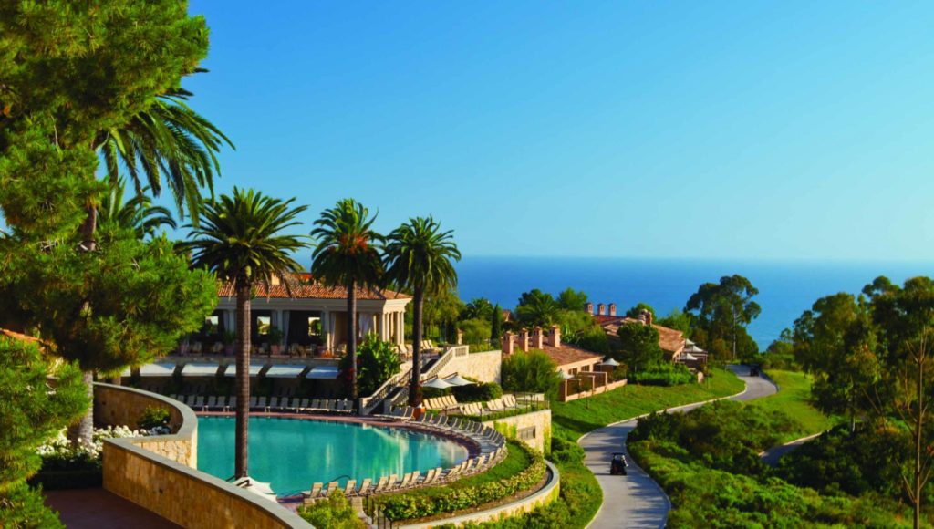 A resort with palm trees and a pool