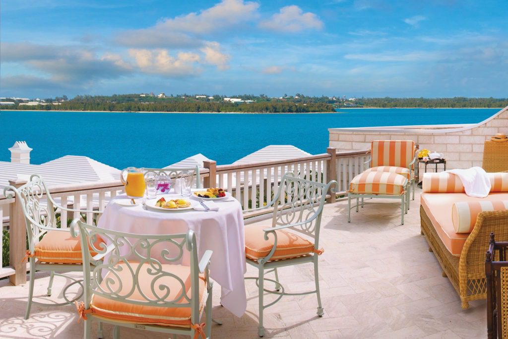 A table with food on it near the water.