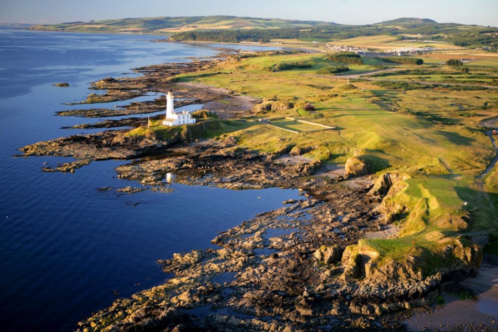 A lighthouse on the edge of an ocean.