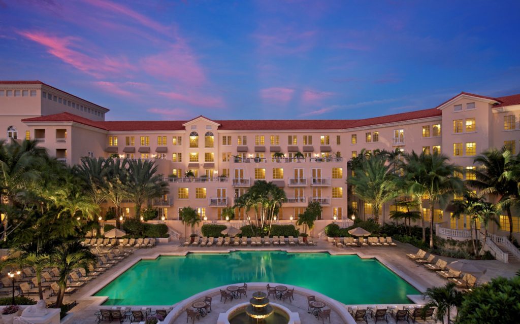 A large pool with many chairs around it