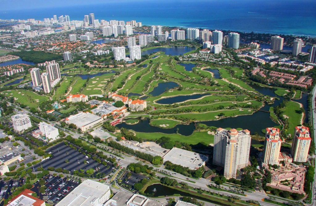 A bird 's eye view of the golf course and surrounding area.