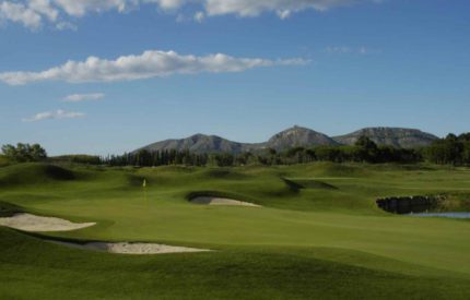 A golf course with mountains in the background.