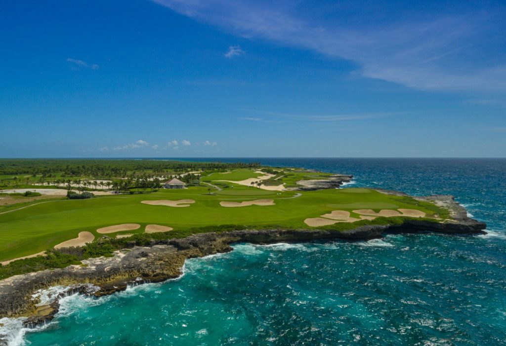 A view of the ocean from above, showing a golf course.