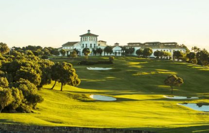 A golf course with many trees and buildings
