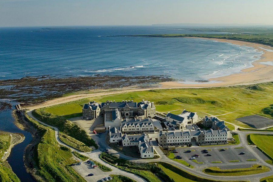 An aerial view of a resort with the ocean in the background.