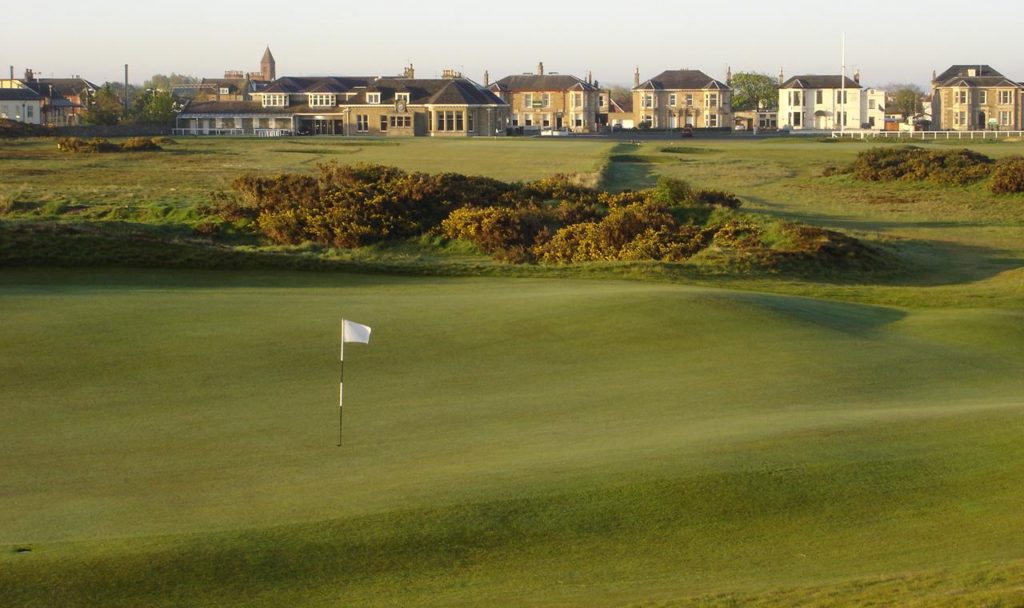 A golf course with a flag on the green.