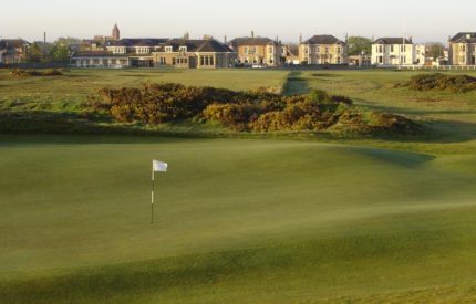 A golf course with a flag on the green.
