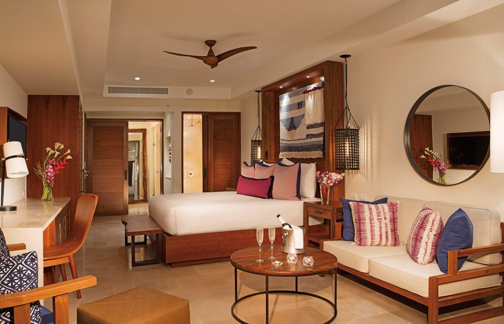 A living room with a bed and a table