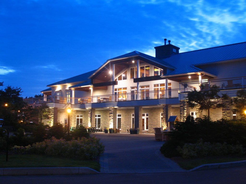 A large building with a balcony at night.