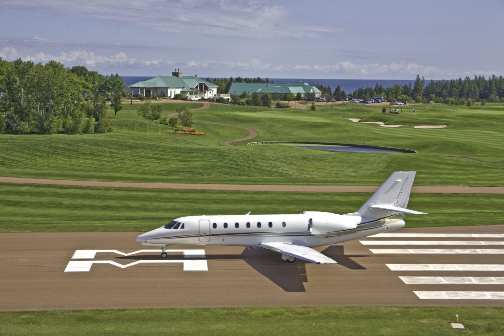 A small white plane sitting on top of an airport runway.