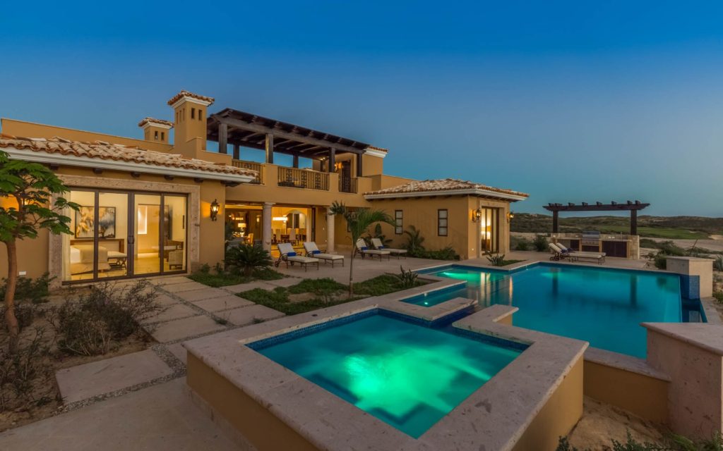 A large pool with a hot tub in the middle of it.