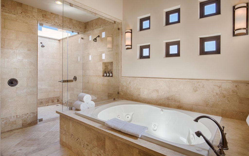 A large bathroom with a tub and shower.