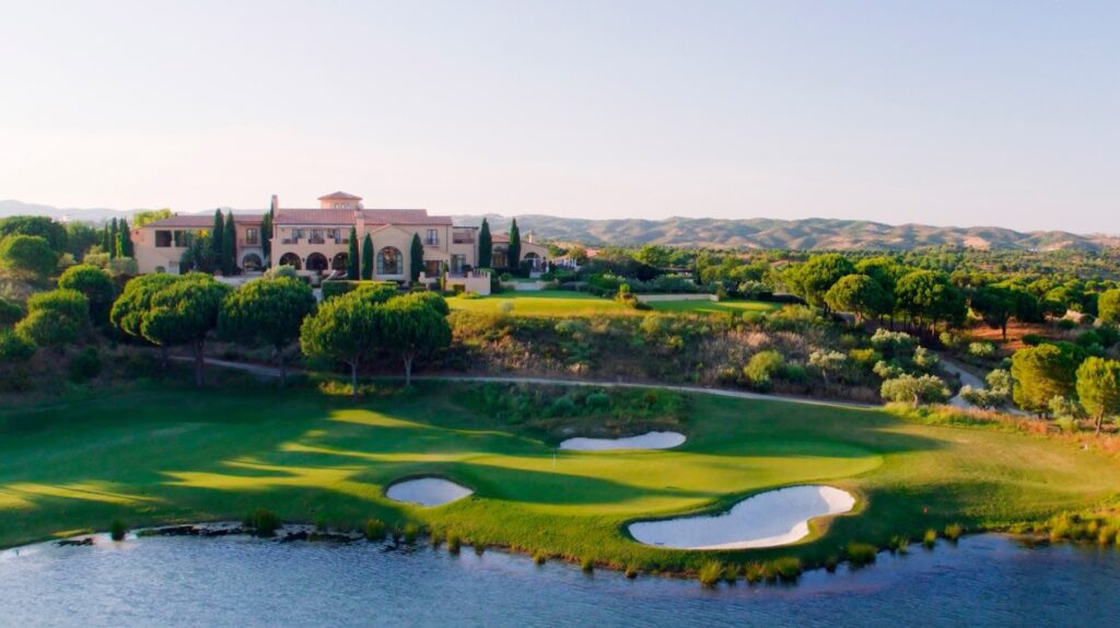 A golf course with many green areas and buildings.