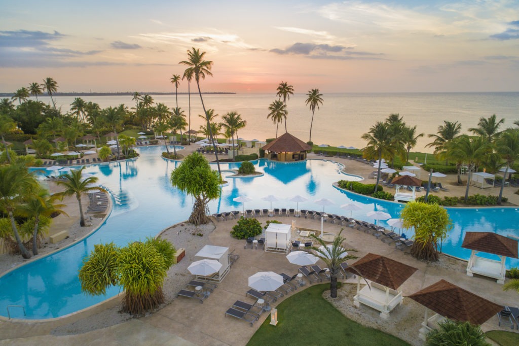 A resort with swimming pools and palm trees.