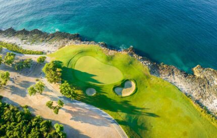 Aerial view of a golf course by the sea.