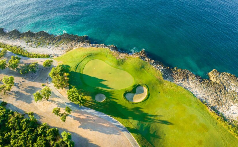 Aerial view of a golf course by the sea.