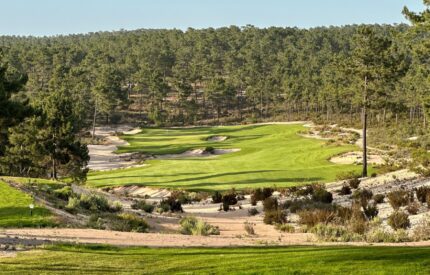 Golf course with green grass and sand bunkers.