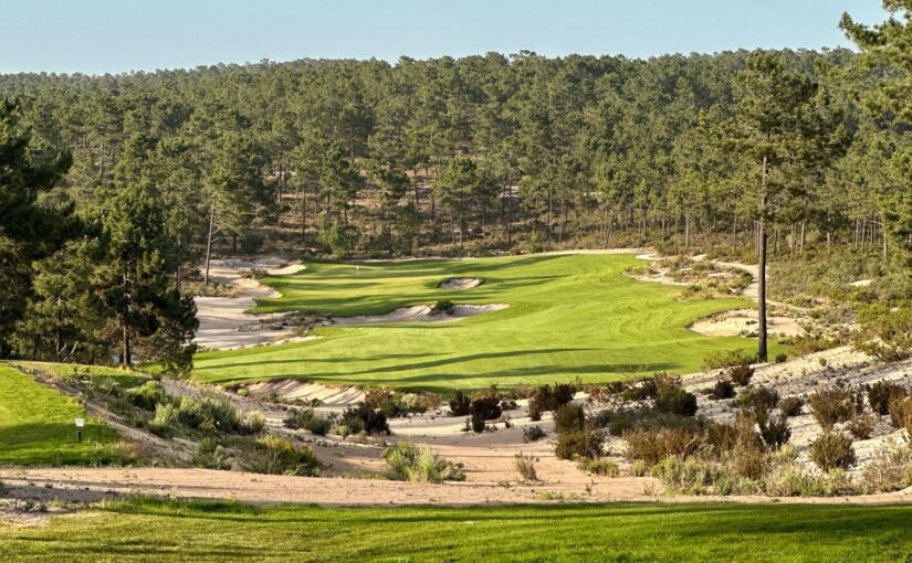 Golf course with green grass and sand bunkers.