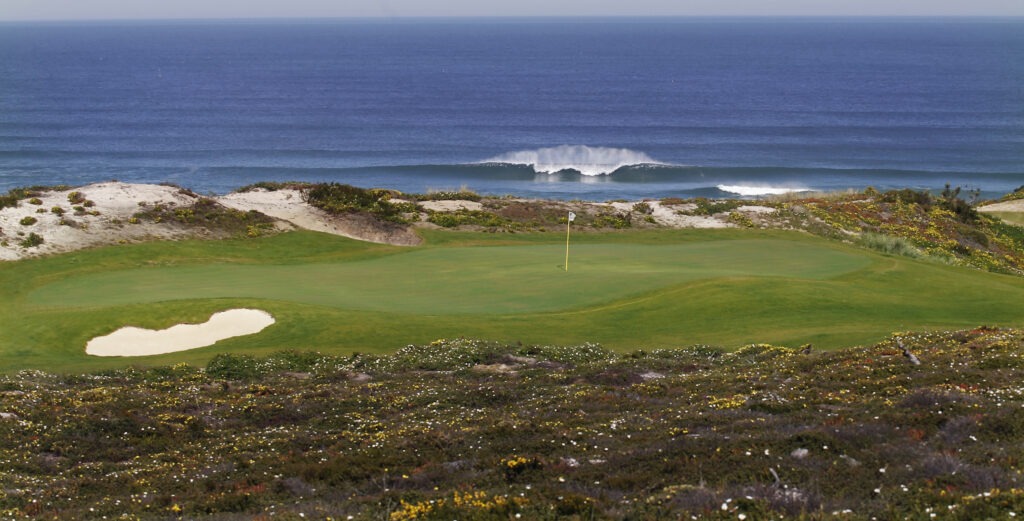 Oceanside golf course with sand trap.