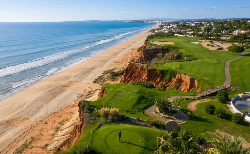 Golfer on a cliffside golf course overlooking the ocean.